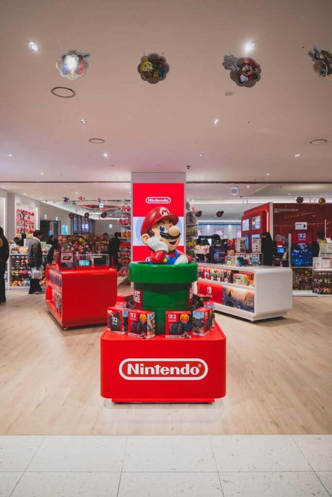 A large Super Mario character statue greets visitors at the entrance, with a Nintendo Switch 2 display stand set up just behind it