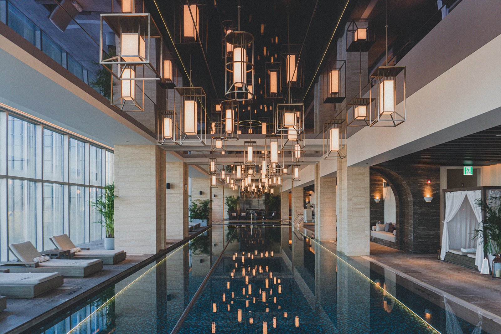 The 25m lap pool on the 26th floor of Josun Palace Gangnam, with a mirrored ceiling and hanging light installation