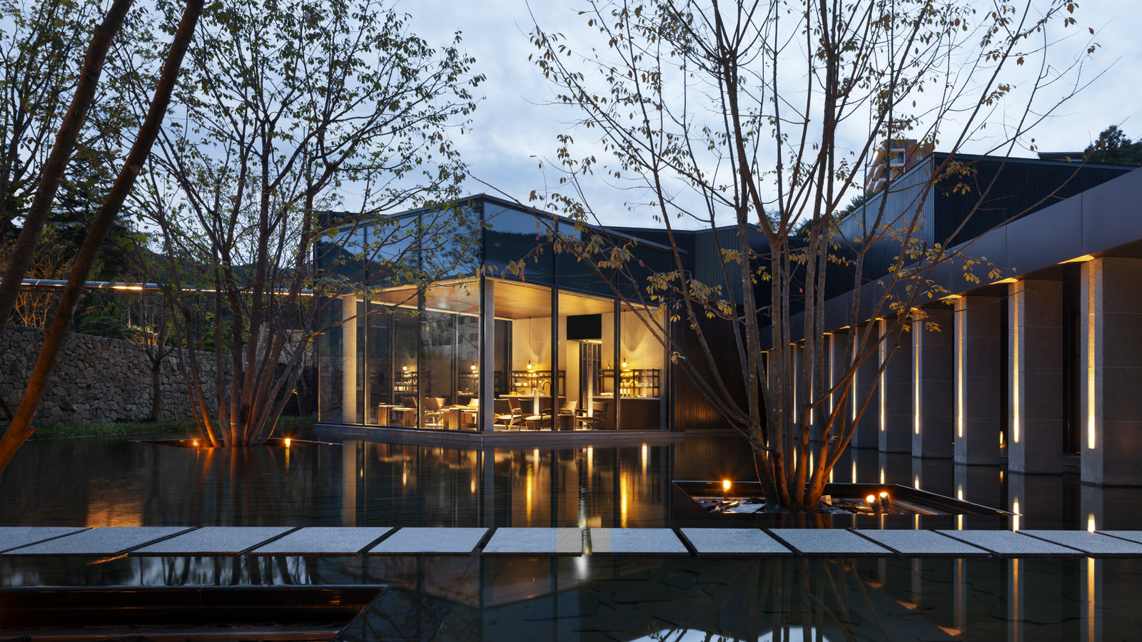 Yuwonjae exterior at dusk with private gardens and outdoor hot spring baths visible. Credit: Yuwonjae official site