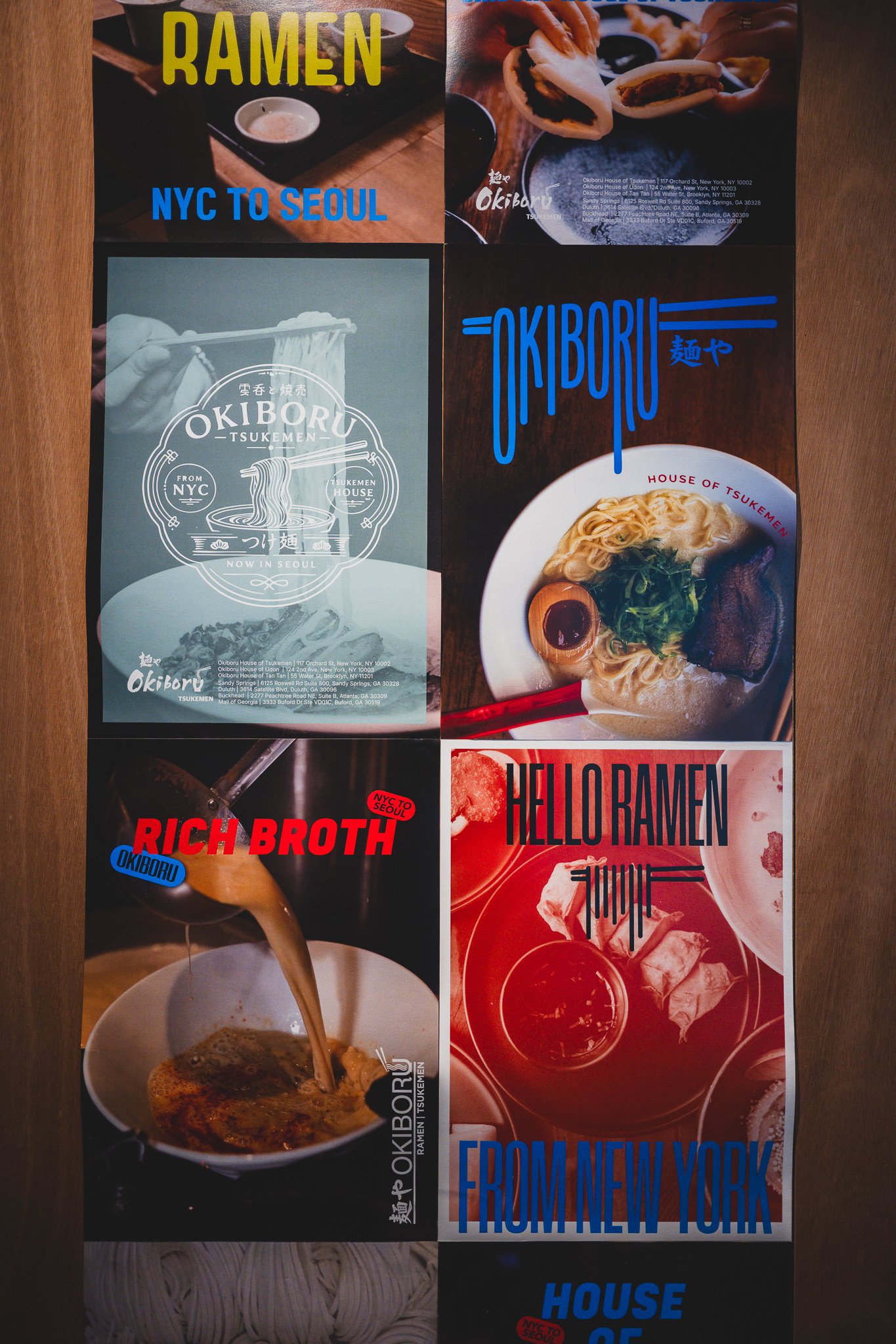 Wall collage of graphic posters reading "RICH BROTH," "HELLO RAMEN FROM NEW YORK," and "FROM NEW YORK"