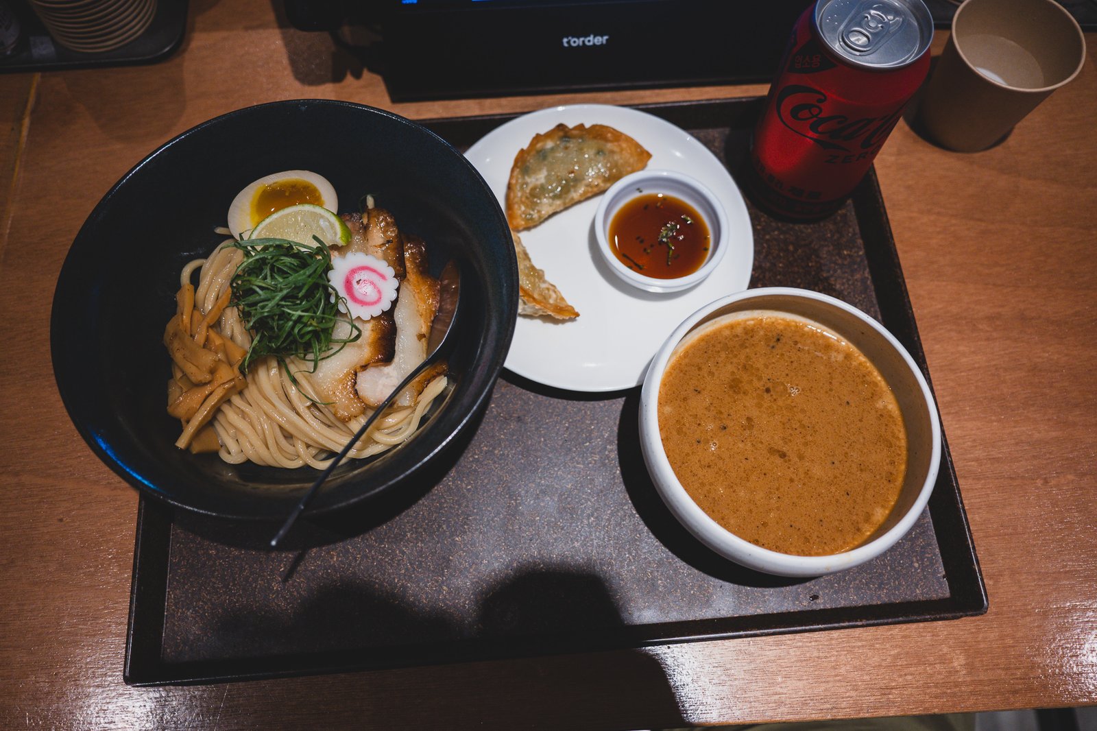 Full lunch set tray with tsukemen, gyoza, wari-sup pitcher, and a can of Coke Zero