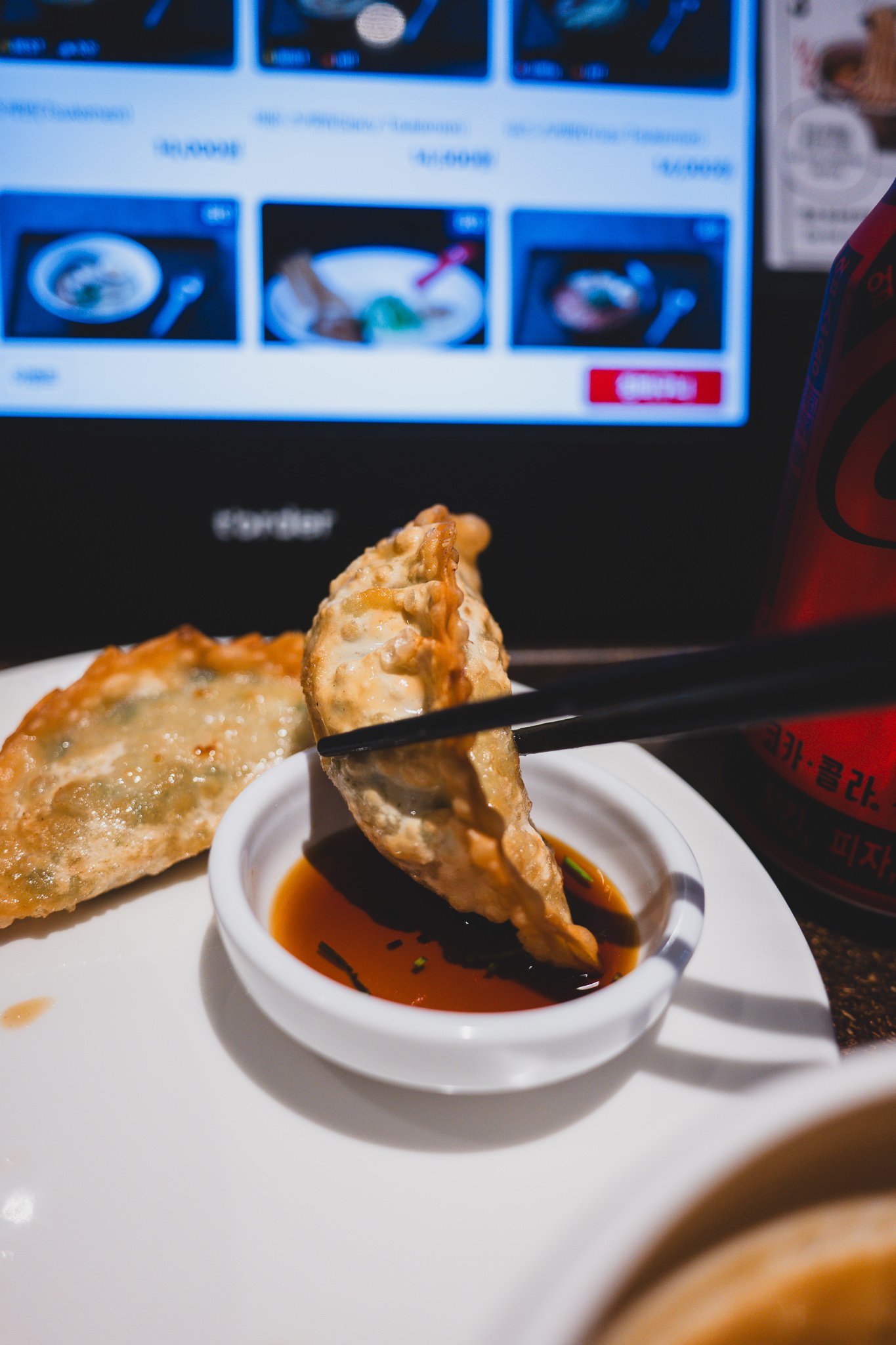 Dipping a gyoza piece into soy sauce