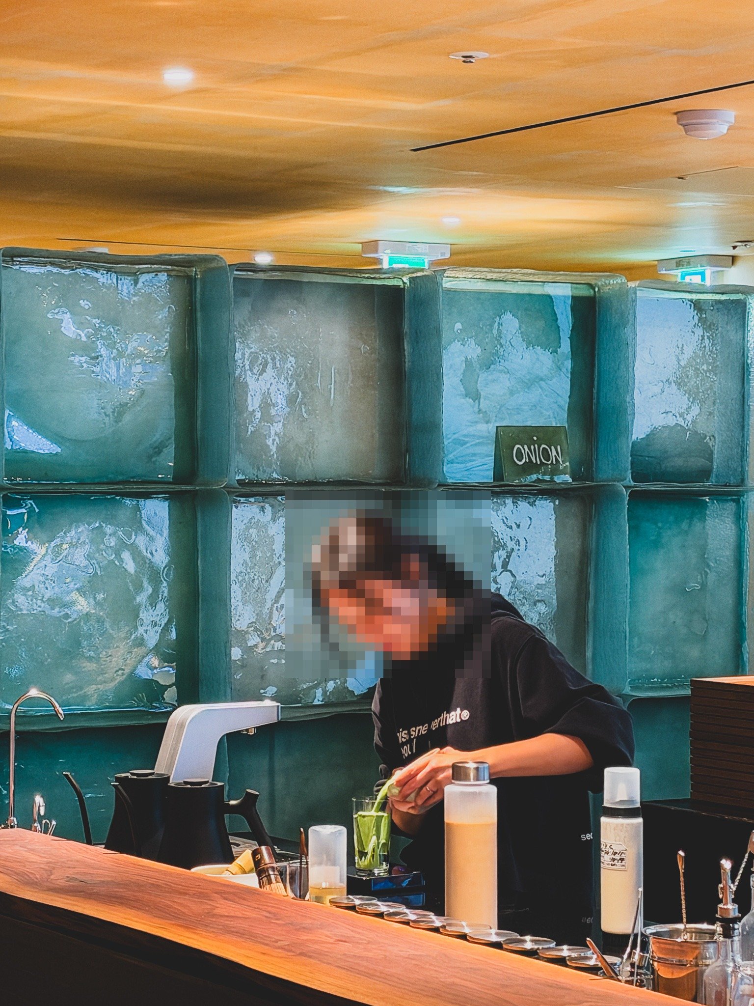 Barista preparing a green tea pour at the 2nd floor bar