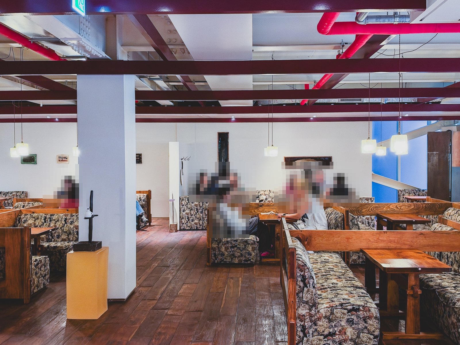 3rd floor seating area with red steel beams and floral sofas