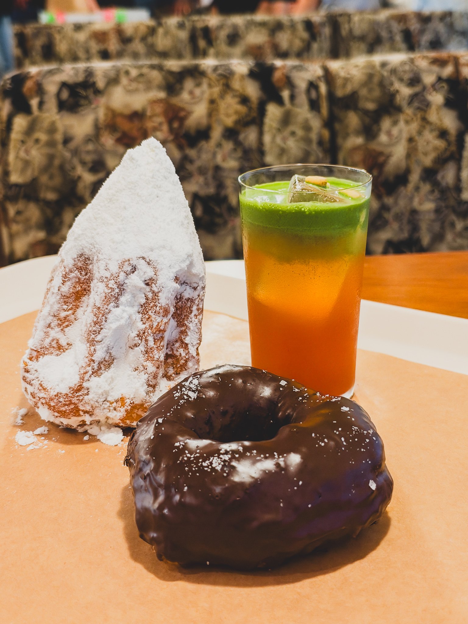 Table with pandoro, chocolate donut, and sujeonggwa drink